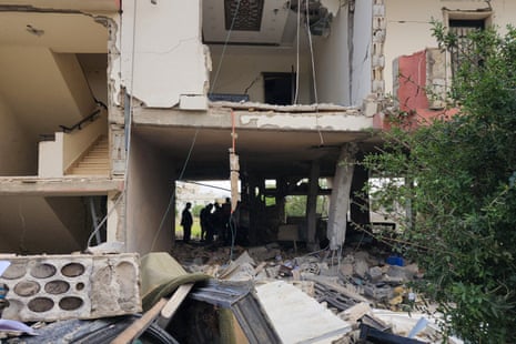 Emergency workers inspect the damage after an Israeli strike on an apartment building in Baalbek on 18 May 2026.