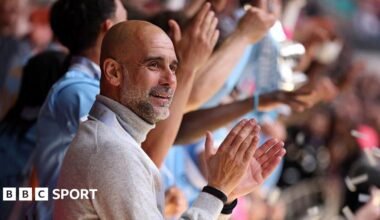 Manager Pep Guardiola applauds as his Manchester City players lift the FA Cup trophy after beating Chelsea in the 2026 final
