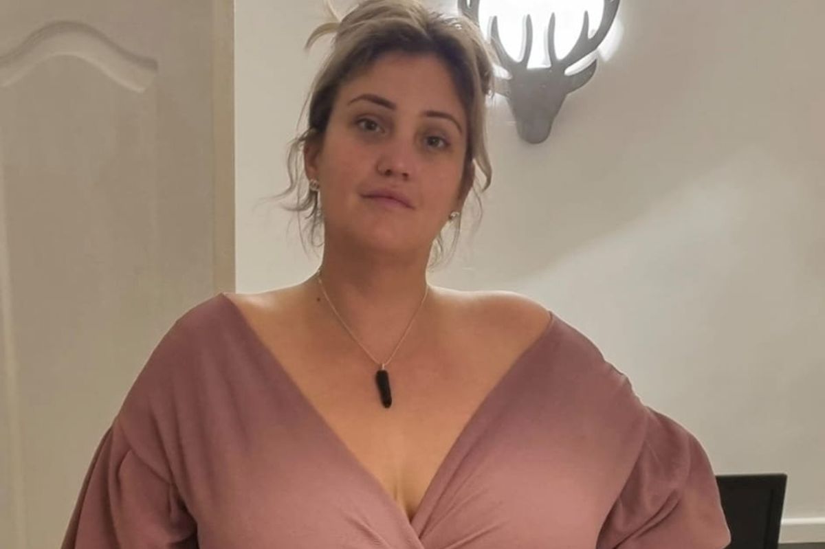 Pam wearing a brown dress