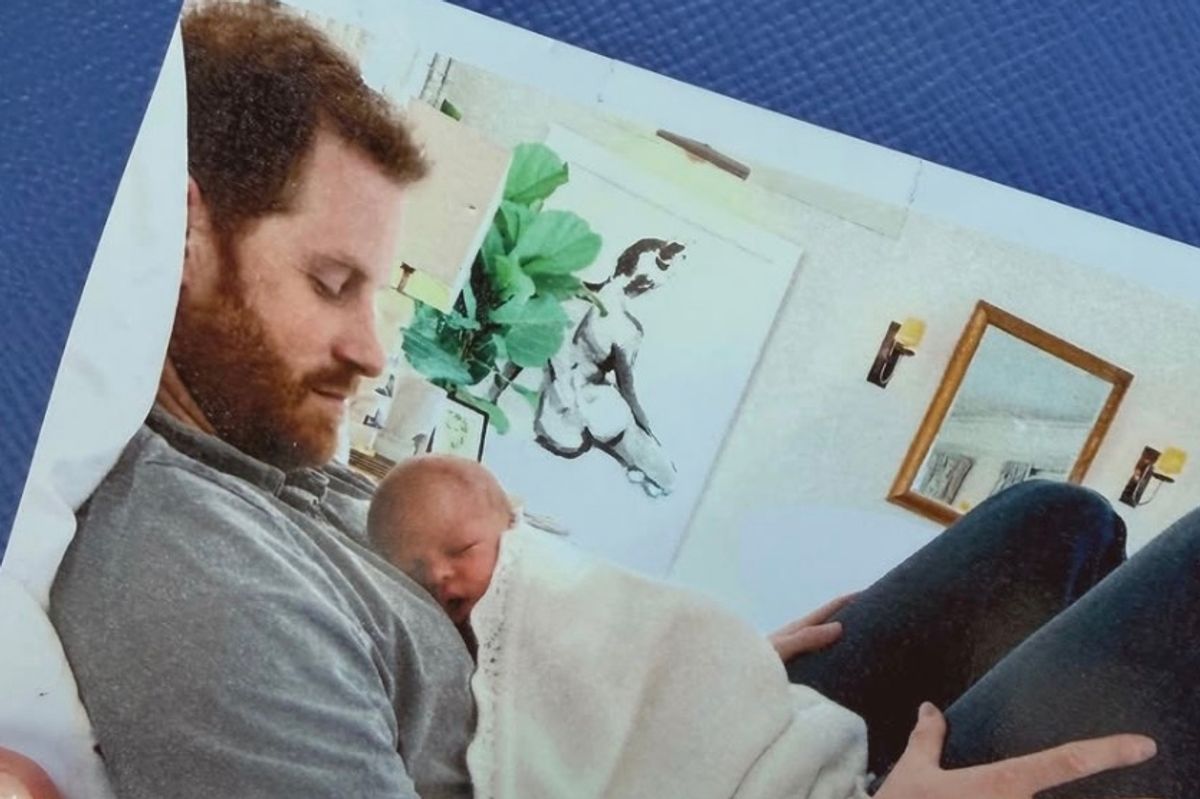 Prince Harry is pictured with baby Archie in the new picture Meghan shared