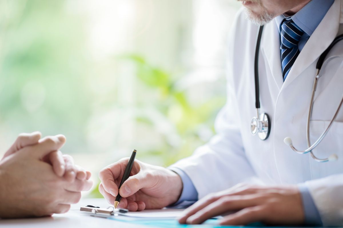 Doctor and patient taking notes in medical surgery