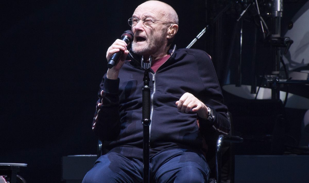 Genesis frontman Phil Collins performing on stage during his last show in 2022