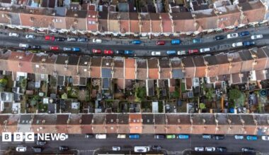 An aerial drone photo showing rows of housing in Bristol and streets lined with cars.