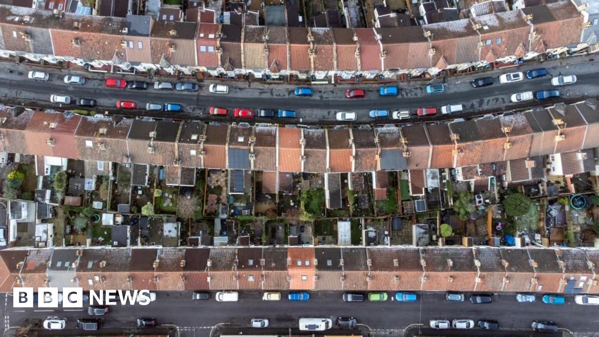 An aerial drone photo showing rows of housing in Bristol and streets lined with cars.