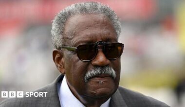 Sir Clive Lloyd, wearing a suit and sunglasses