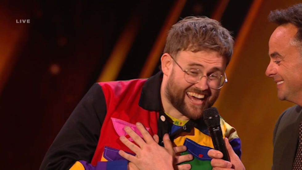 britains got talent ted hill two individuals engaged in conversation on stage during a live event