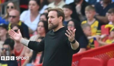 Rob Elliot spreads his arms wide in a gesture of helplessness on the touchline