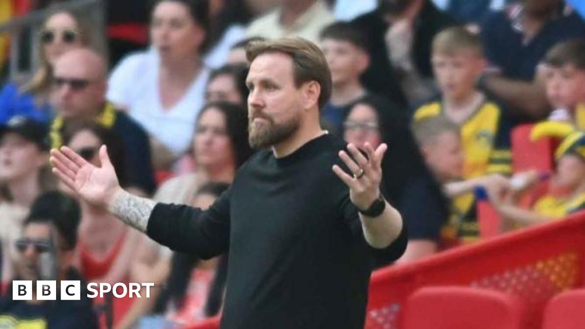 Rob Elliot spreads his arms wide in a gesture of helplessness on the touchline
