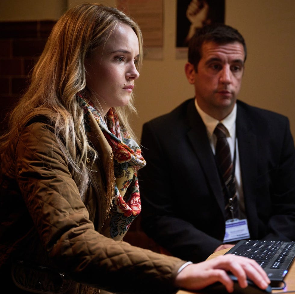 interaction between a woman and a man at a computer station interaction between a woman and a man at a computer station