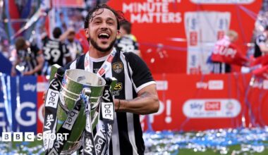Jodi Jones holds the League Two play-off final trophy at Wembley
