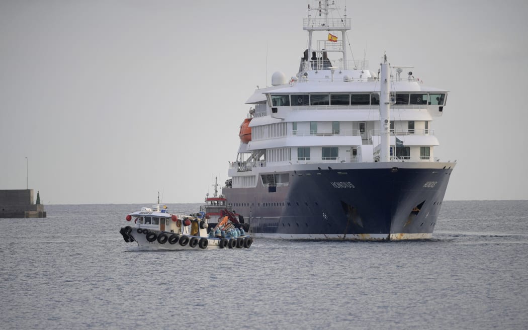 US passengers from the Dutch flagged hantavirus-stricken cruise ship MV Hondius are transferred by boat to the industrial port of Granadilla de Abona on the island of Tenerife in Spain's Canary Islands on May 10, 2026. Repatriation flights for the nearly 150 passengers onboard the ship hit by a deadly hantavirus outbreak got underway as passengers and some crew members were transferred to shore on smaller vessels then by bus to the airport and then flown home after weeks at sea.
