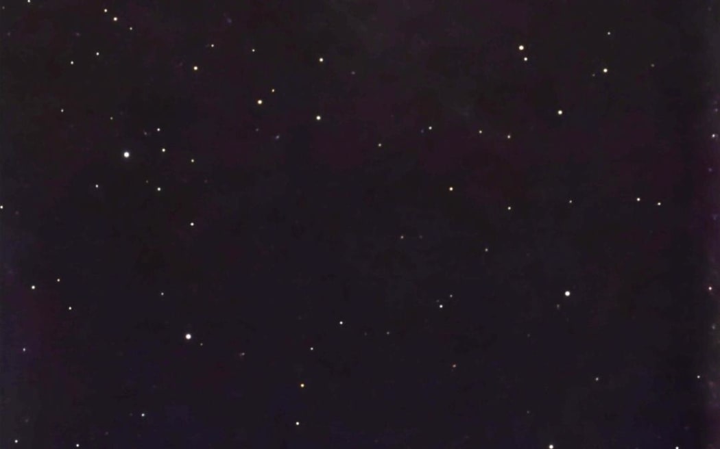 The comet up close in the night sky.