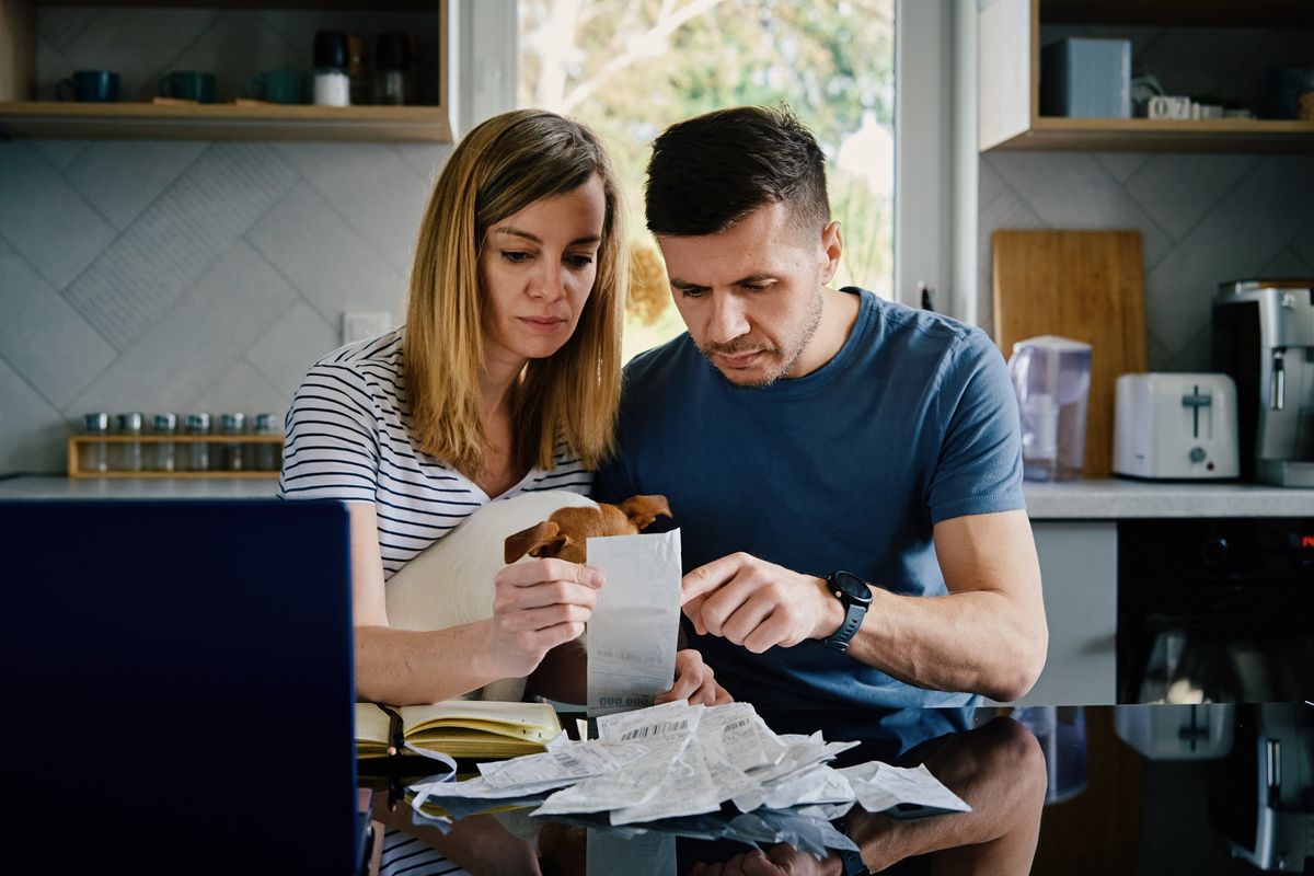 Couple looking at bill worried