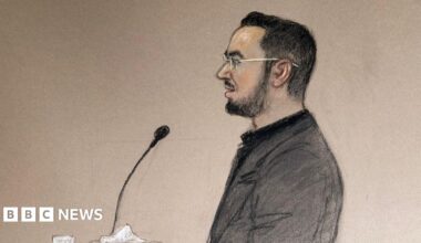 A court sketch of Pouria Zeraati giving evidence in the trial of two men accused of stabbing him. He has black hair and a black beard and is wearing a grey suit jacket.
