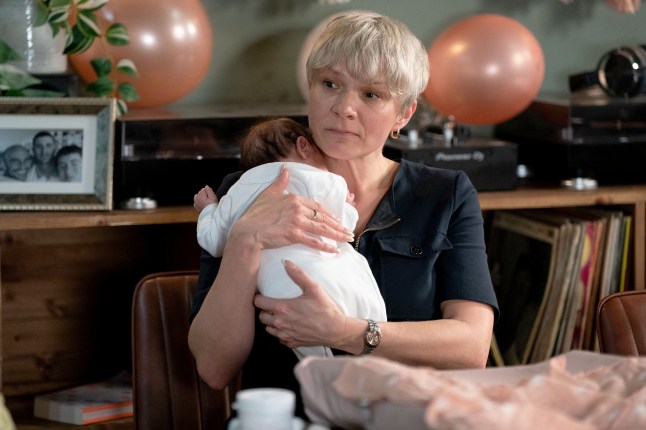 Nicola Mitchell holding baby Ivy over her shoulder in EastEnders