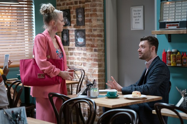 Linda and Johnny Carter having a tense talk in the cafe in EastEnders