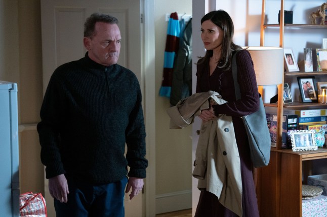 Billy standing with Bea in his home in EastEnders