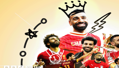 A stylised image shows a smiling Mohamed Salah, in a short-sleeved red Liverpool jersey with the word "Champions" on it, celebrating on the pitch, in front of fans, with their images turned black and white, holding the Premier League Trophy, festooned with red ribbons. A crown has been drawn on his head in black lines.