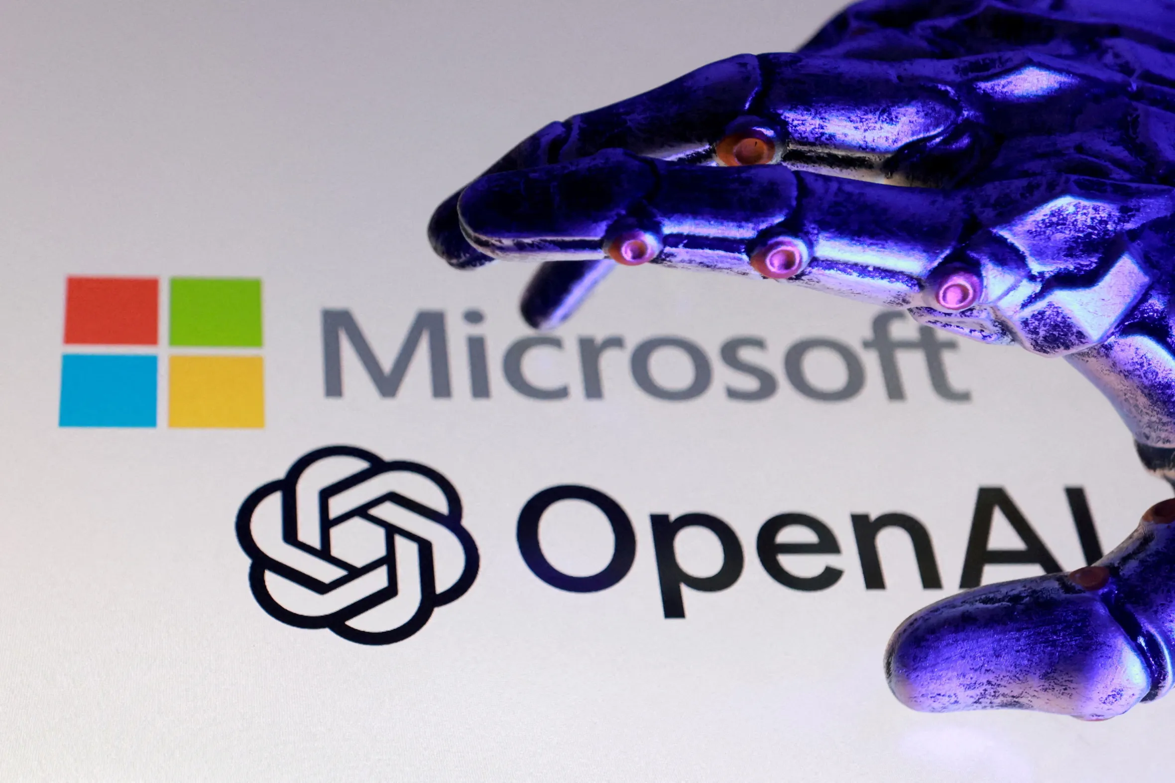 Illustration shows the Microsoft logo and the OpenAI logo with a robotic hand.