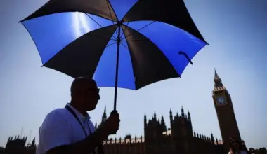 A pedestrian shelters from the sun on Westminster Bridge in London, on May 25. The UK has recorded it’s hottest May day on record, with temperatures hitting 34.8 deg C in parts of London.
