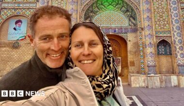 Selfie showing Lindsay and Craig Foreman outside a mosaic building.