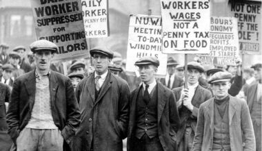 A group of workers holding up placards, one reading, "Not a penny off the workers' wages not a penny tax on food."