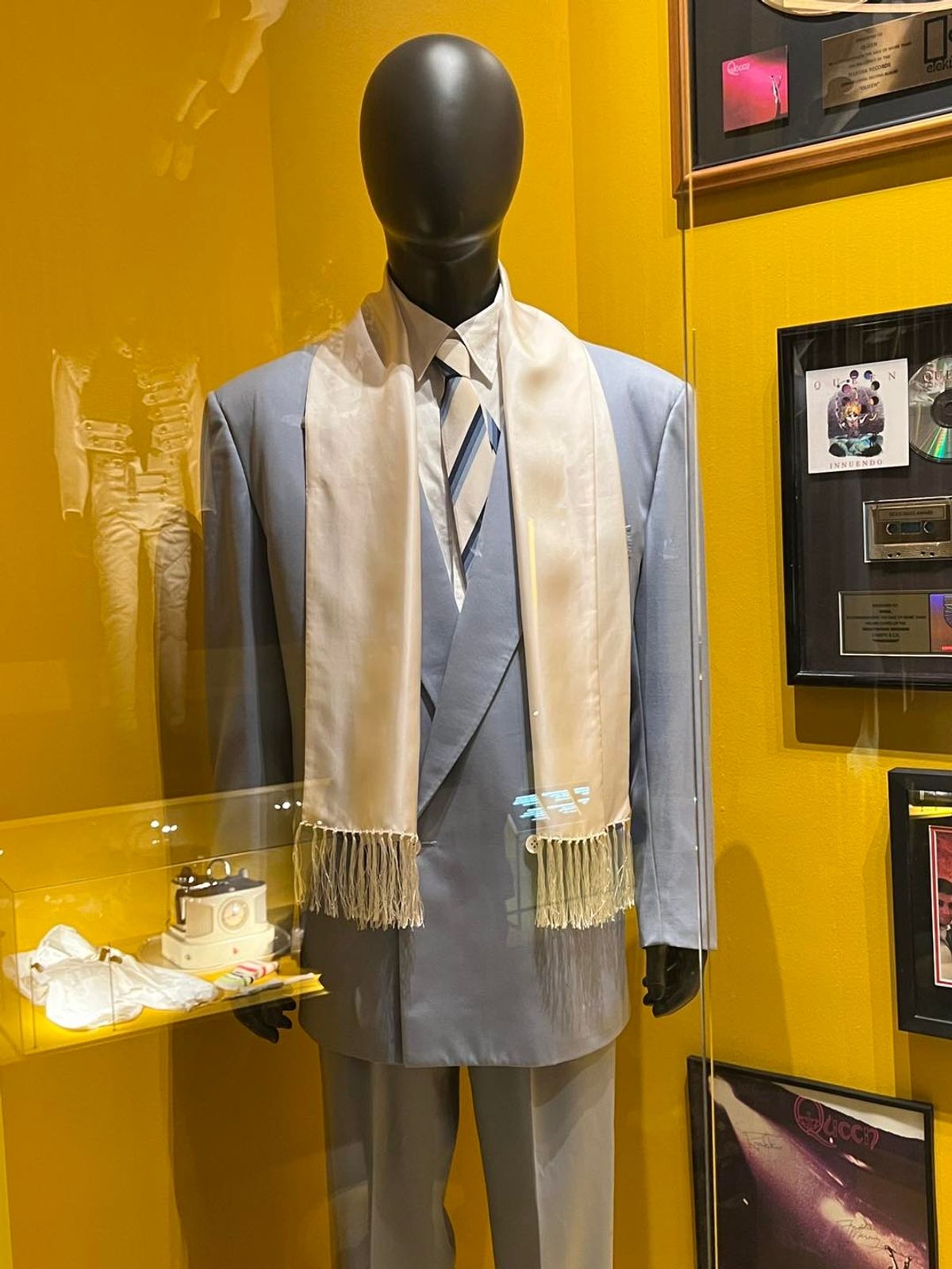 The pale blue suit worn by Freddie at his last public appearance at the 1990 Brit awards, with a selection of gold and silver discs.