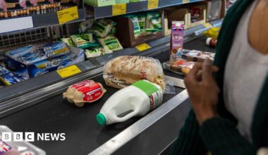 Eggs, bread, milk, and other food on a conveyor belt