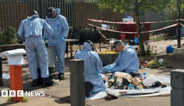 Forensics workers at the scene of a shooting in Brixton, south London