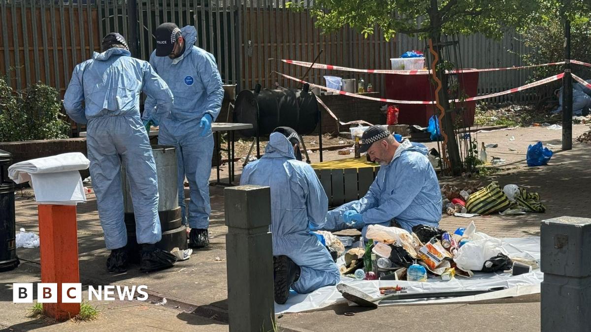 Forensics workers at the scene of a shooting in Brixton, south London