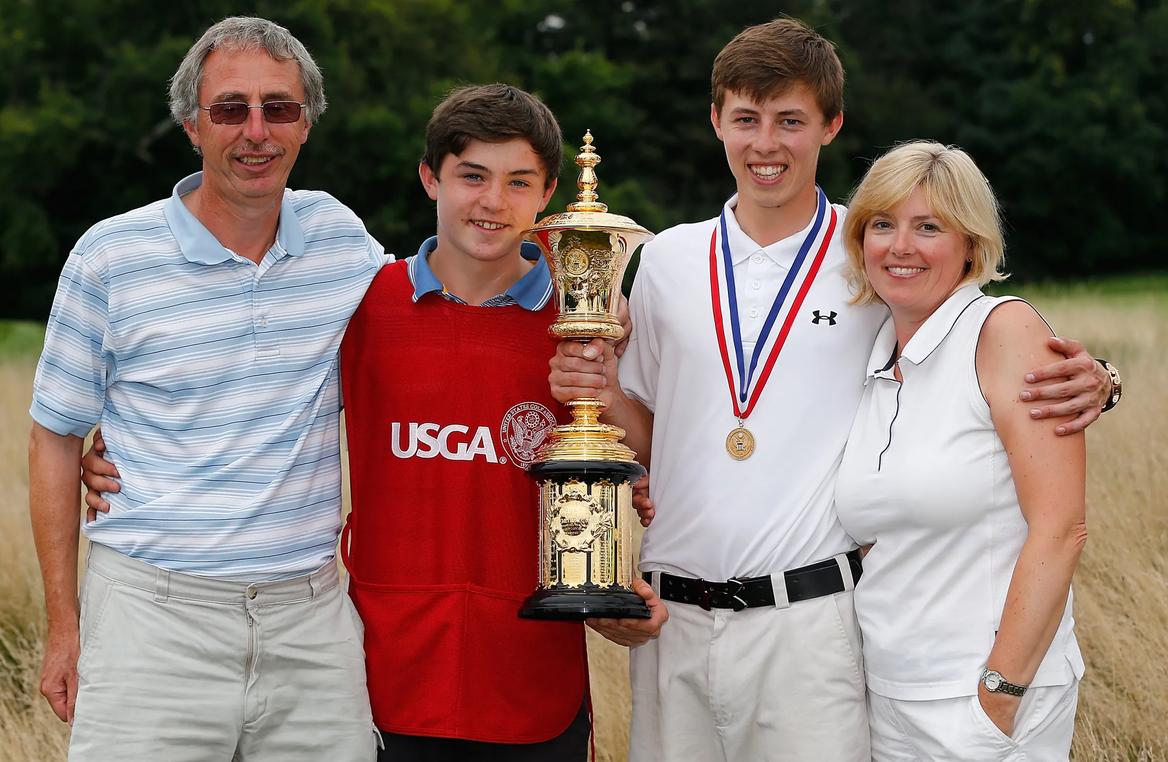 Matt Fitzpatrick holds the Havemeyer Trophy with his father Russell, brother Alex, and mother Sue after winning the 2013 U.S. Amateur Championship.