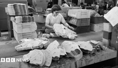 A black and white photo from the 1980s of a woman assembling Millennium Falcons
