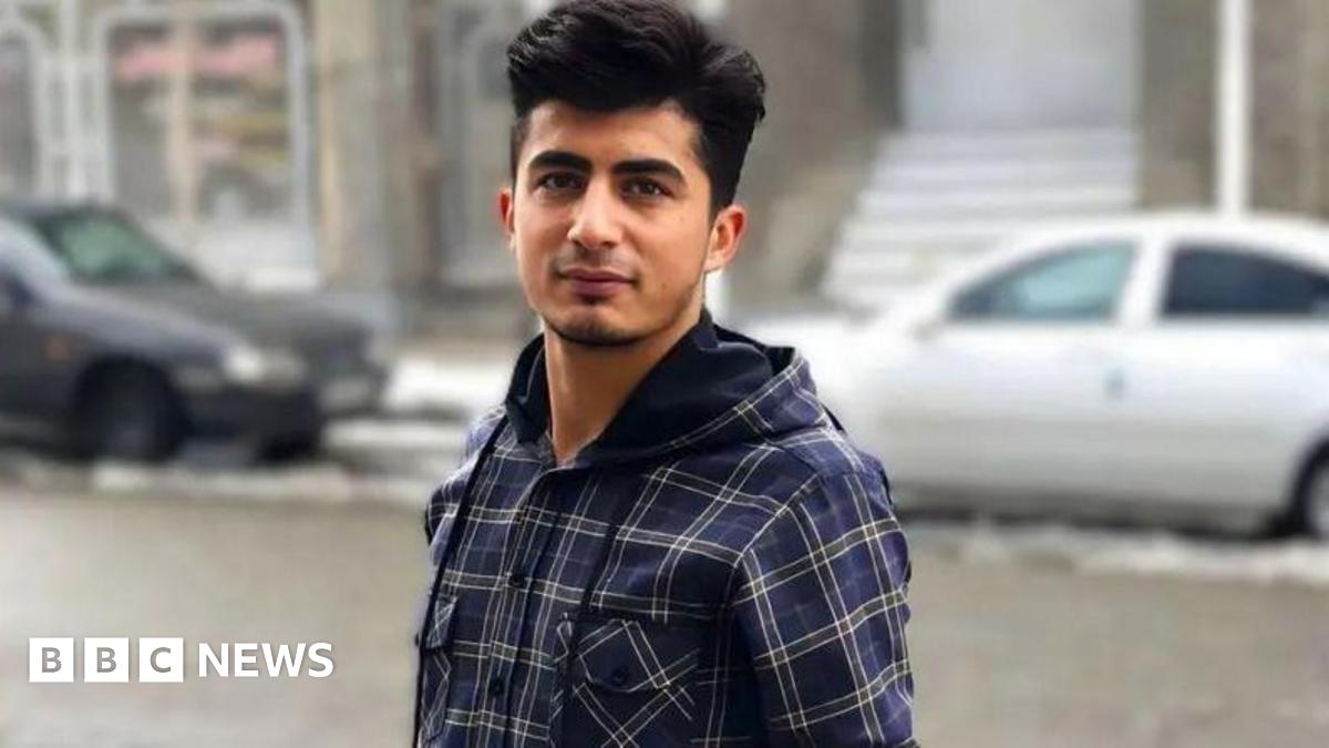 Mehrab Abdollahzadeh looks at the camera. He is wearing a blue chequered shirt.