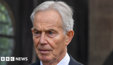 Tony Blair, pictured wearing a dark suit