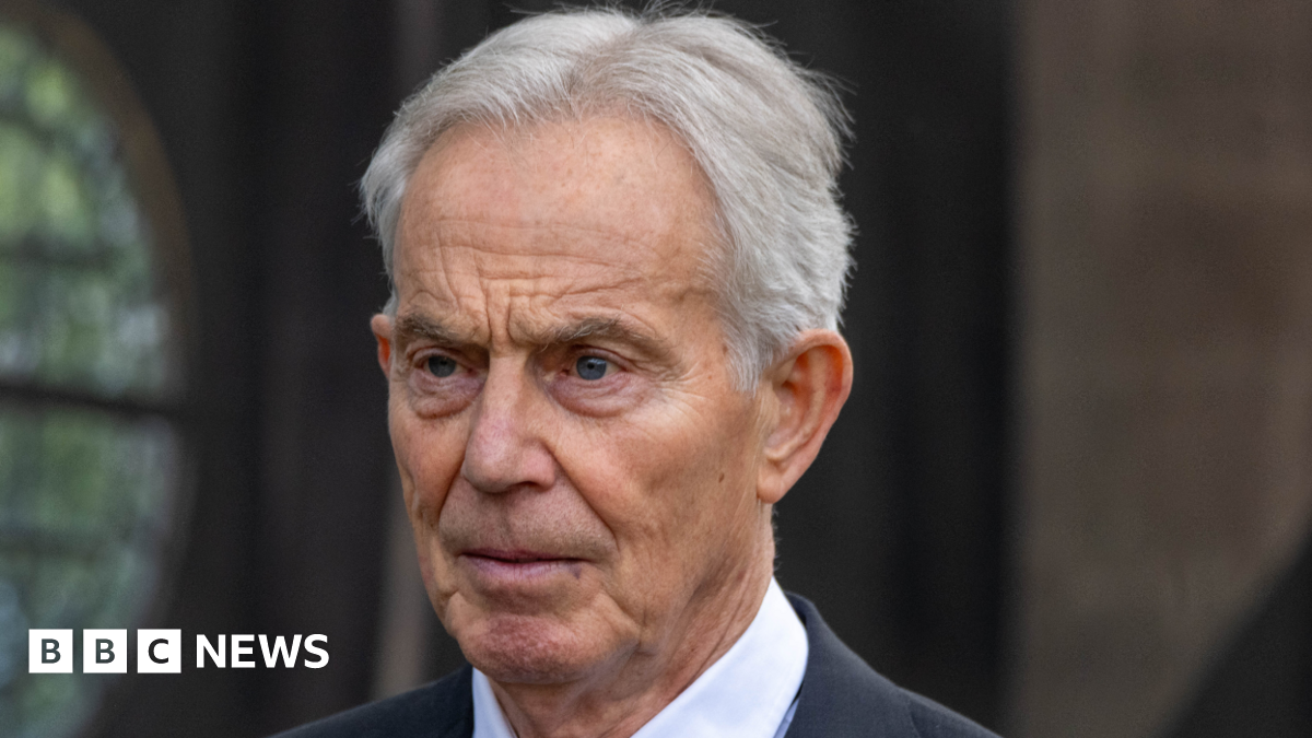 Tony Blair, pictured wearing a dark suit