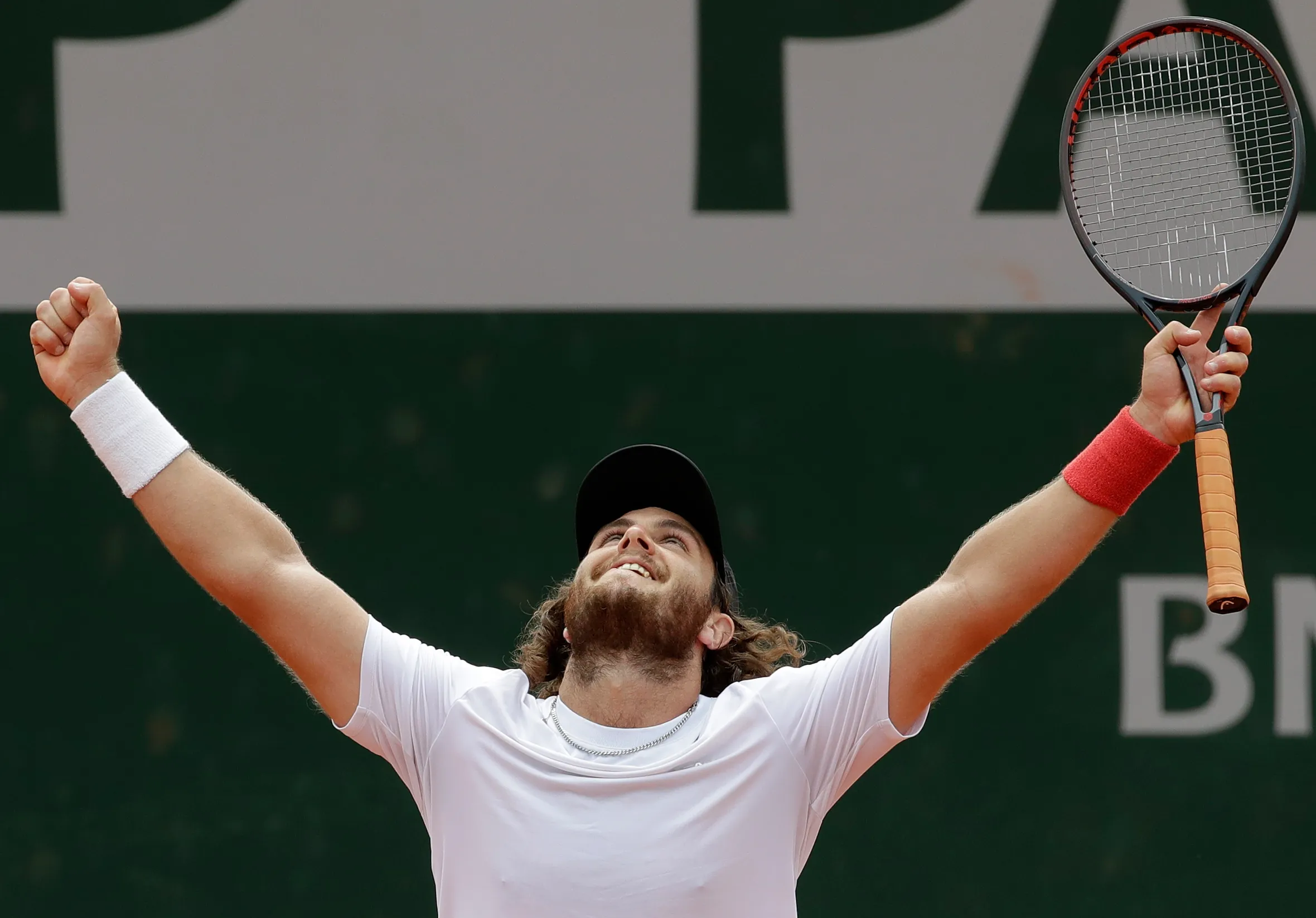 Marco Trungelliti raising his arms in victory after defeating Bernard Tomic at the French Open.