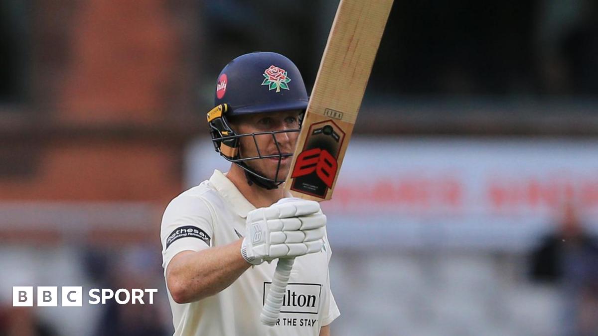Luke Wells raises his bat to celebrate another 50 for Lancashire