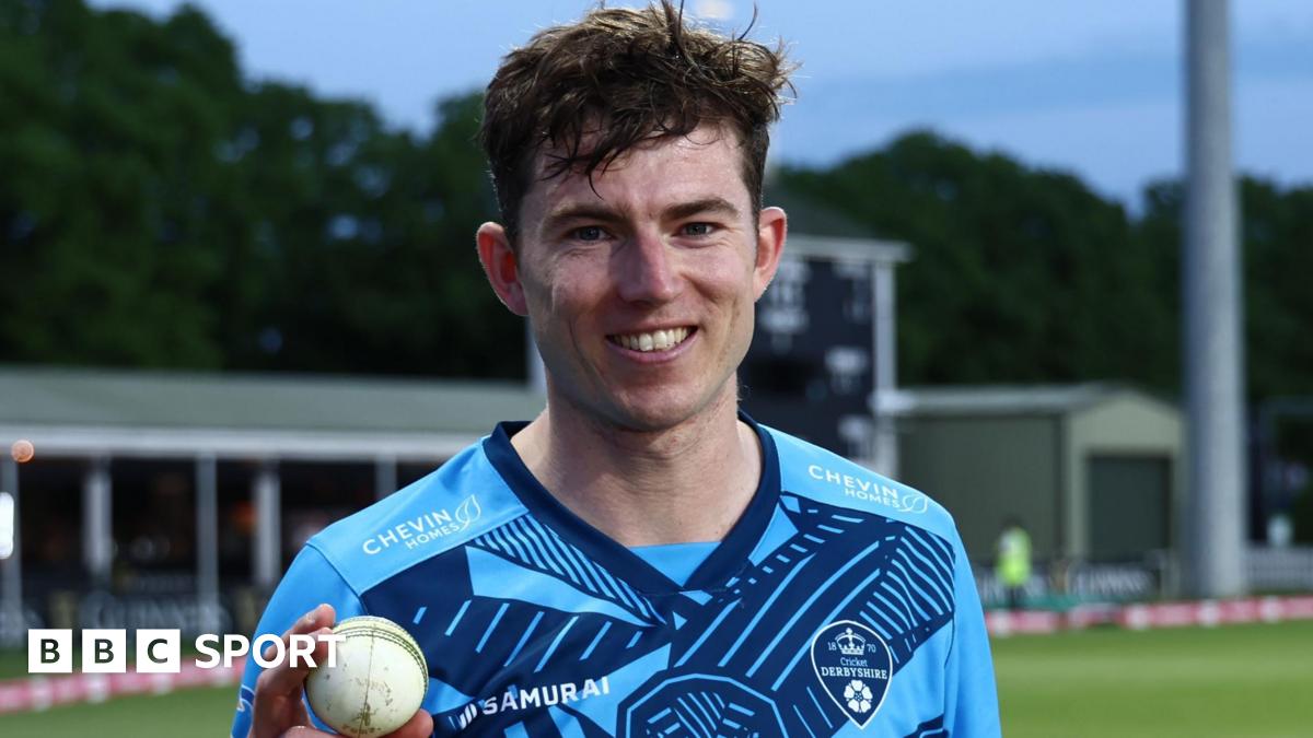 Martin Andersson wearing a blue shirt holds a white ball in his right hand as he smiles to the camera