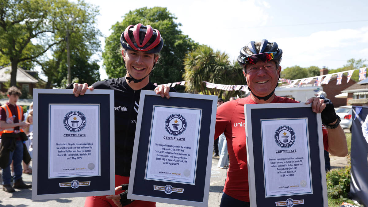 Father and son set three new world records after round-the-world charity cycle