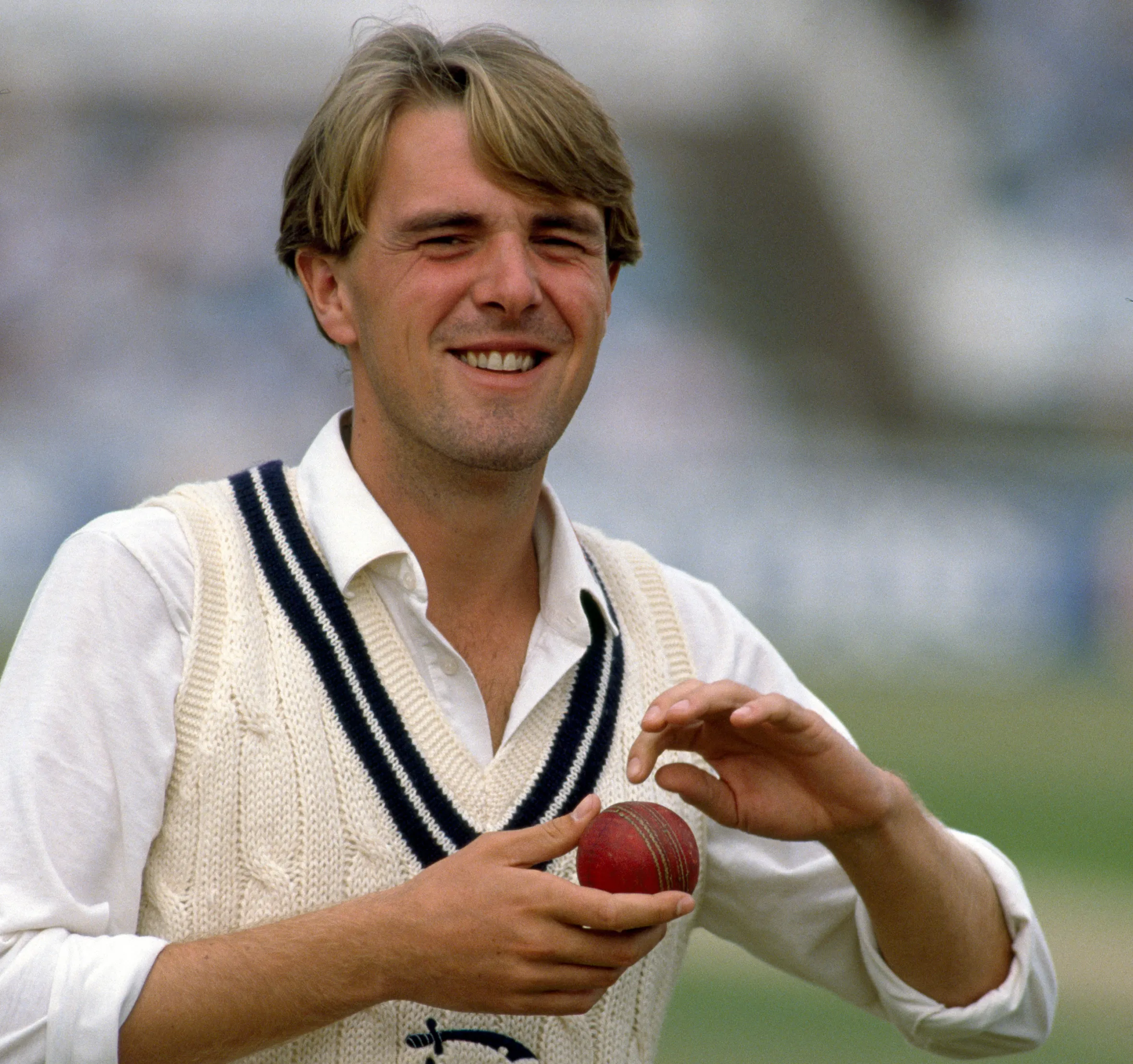 Middlesex bowler Phil Tufnell smiling while holding a cricket ball.