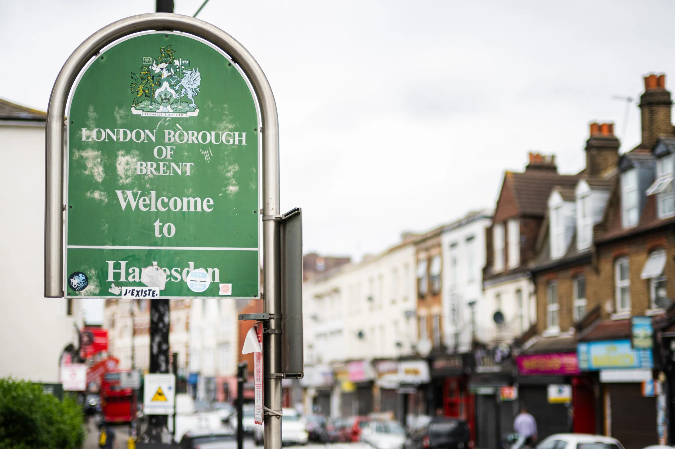 A green sign for the London Borough of Brent welcoming people to Harlesden.