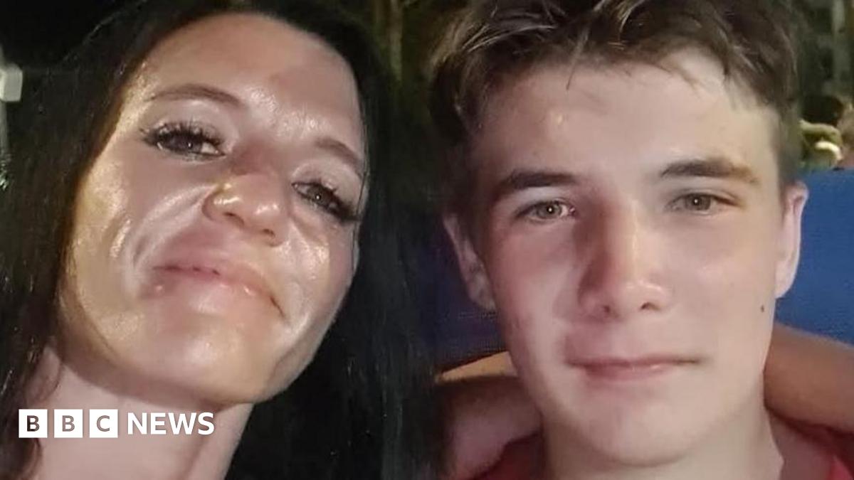 A close-up of Kirsten Coutts with her arm around her son, Sam. She has long black hair and he has short brown hair, both have the same coloured hazel eyes. They are smiling at the camera.