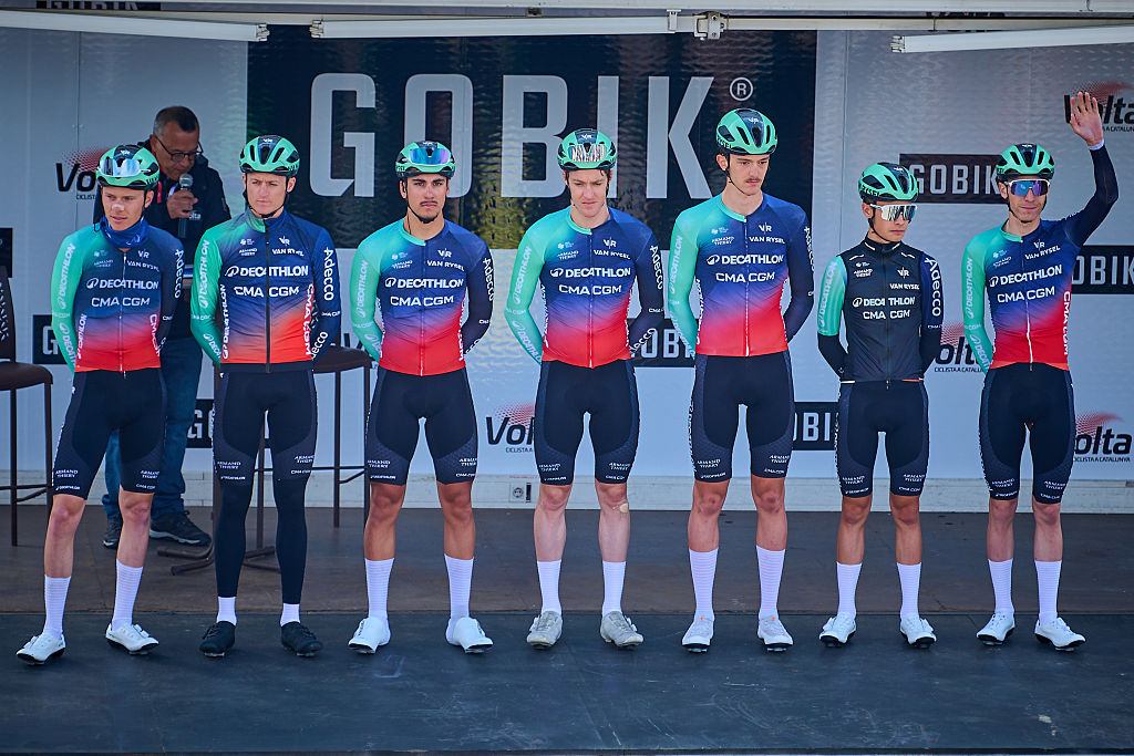 Decathlon CMA CGM riders stand on podium during team presentation