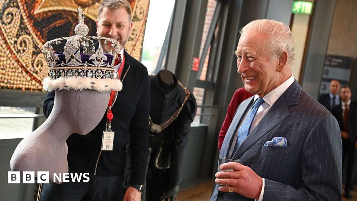 King Charles III laughs as he views a replica crown during a tour of costumes during the interval at the Royal Shakespeare Company's performance of The Tempest at the Royal Shakespeare Theatre in Stratford-upon-Avon, England on 22 May 2026.