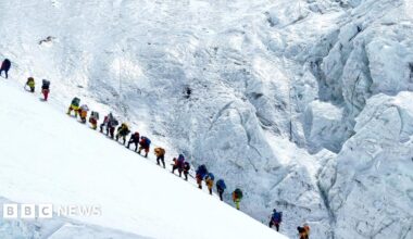 Climbers walk in a long queue as they head to summit Mount Everest in the Solukhumbu distric