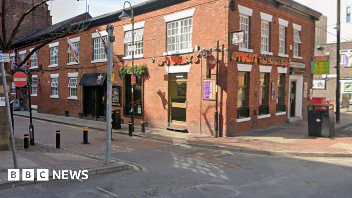 A street corner with a takeaway in a brick building, which has a red sign reading McTucky's Fried Chicken