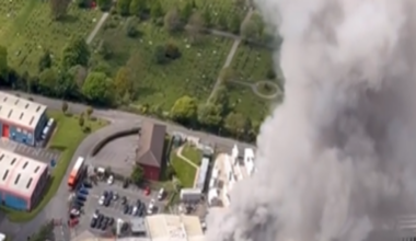 Image taken from a helicopter shows smoke rising from the Warburtons factory in Burnley. A large column on grey smoke rises from the roof the building.