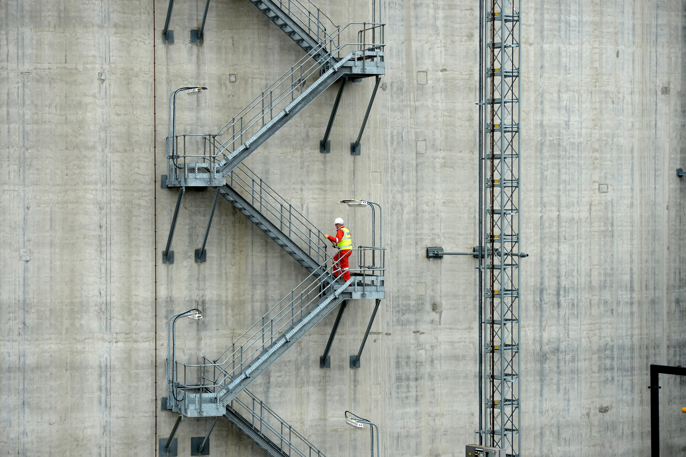 Production manager Kevin Shears ascends a storage tank at National Grid's liquefied natural gas plant.