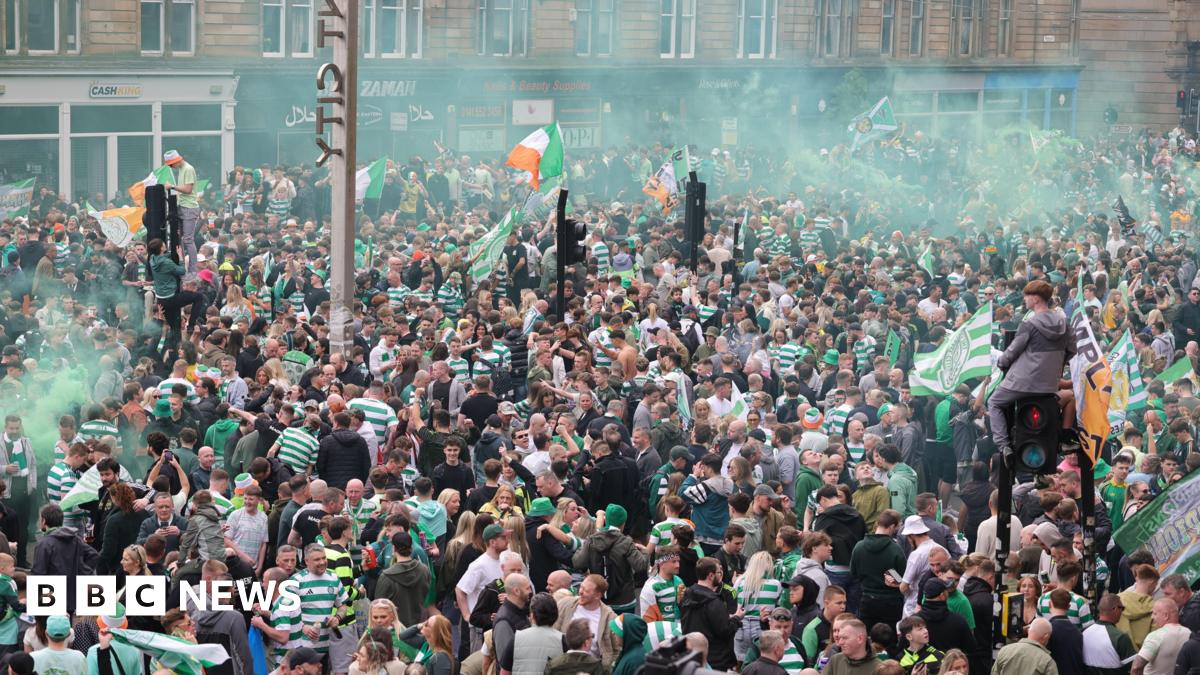 Hundreds of Celtic fans on city streets in Glasgow, letting off smoke bombs and climbing up lamp posts as they celebrate their side winning the league title.