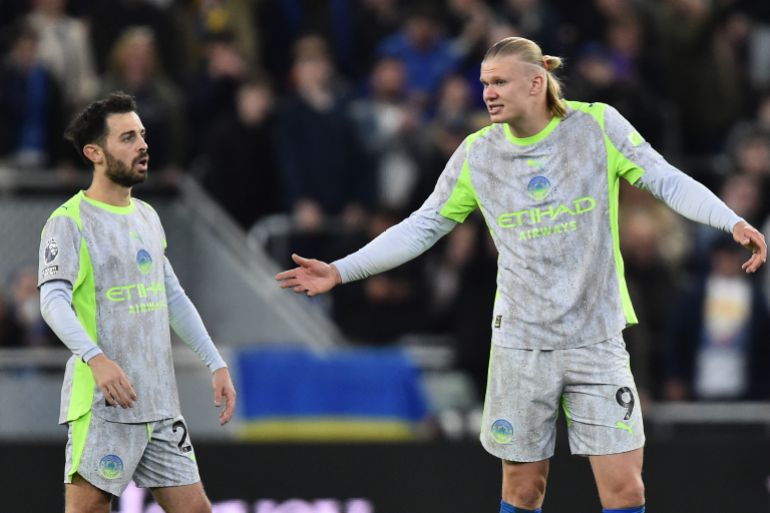 (LtoR) Manchester City's Portuguese midfielder #20 Bernardo Silva and Norwegian forward #9 Erling Haaland react after conceding a goal during the Premier League football match between Everton and Manchester City at Hill Dickinson Stadium in Liverpool on May 4, 2026. (Photo by PETER POWELL / AFP)